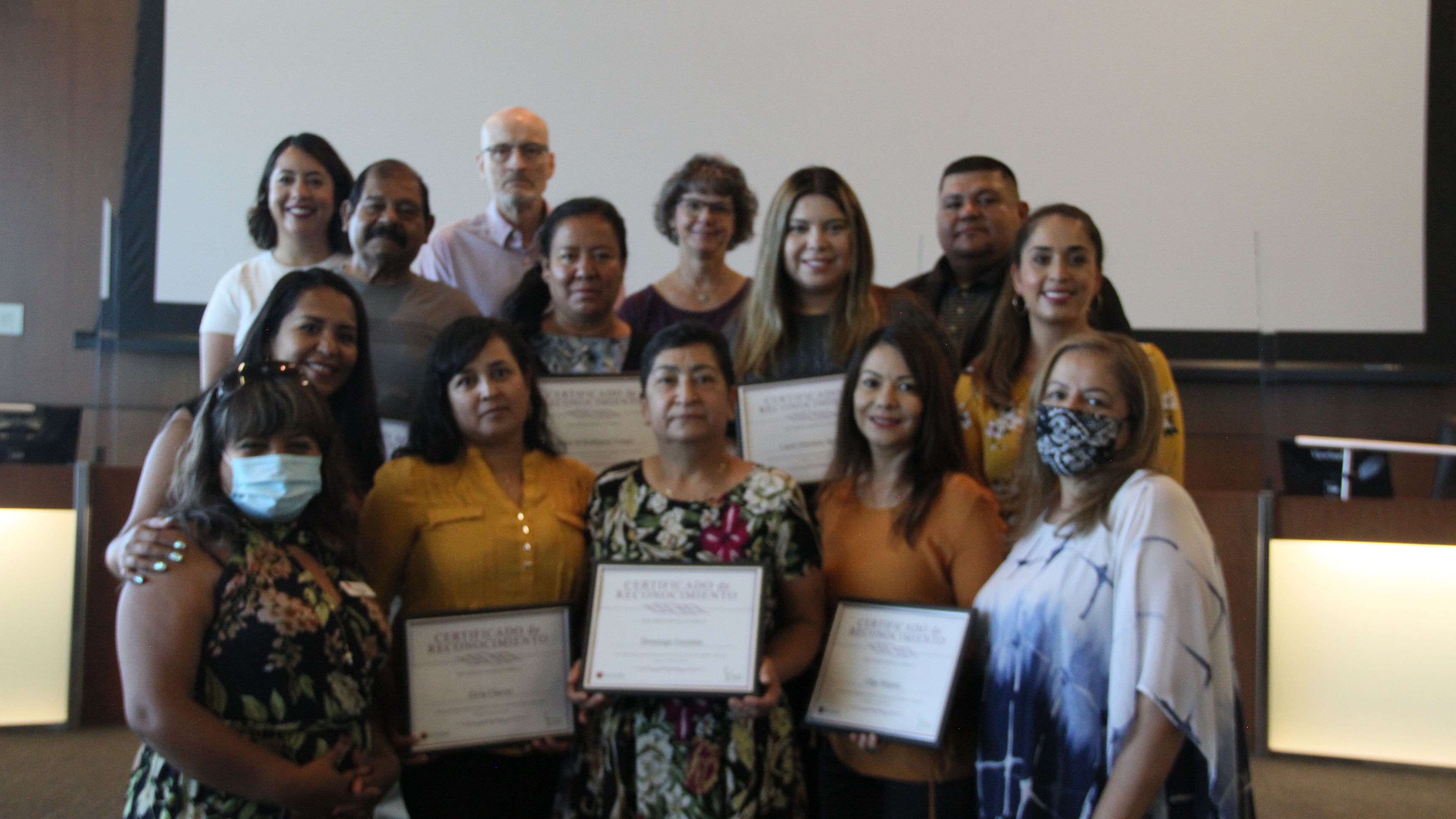 Group of people holding up plaques. 