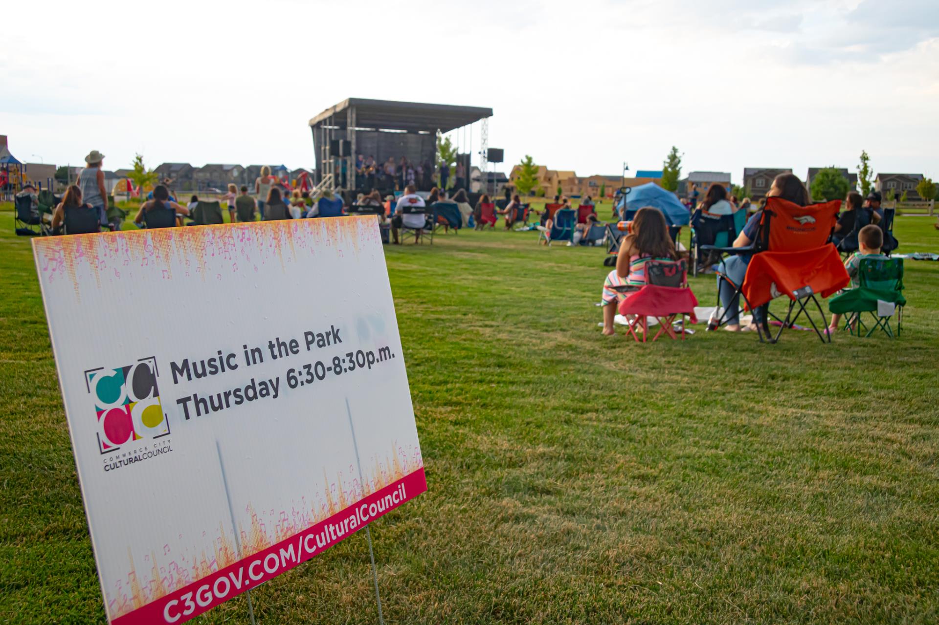 A crowd enjoying music in the park