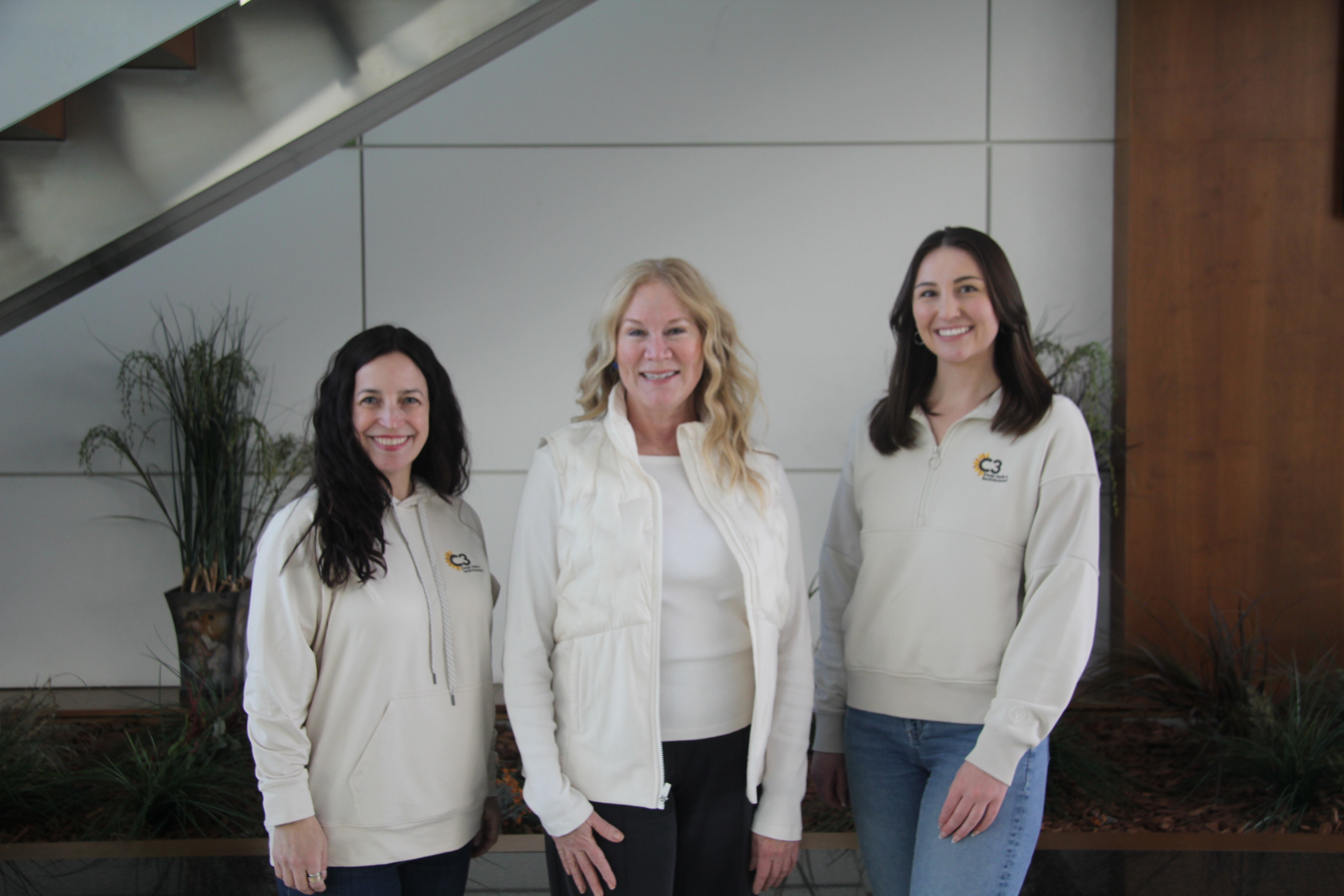 Three women posing for a photo. 