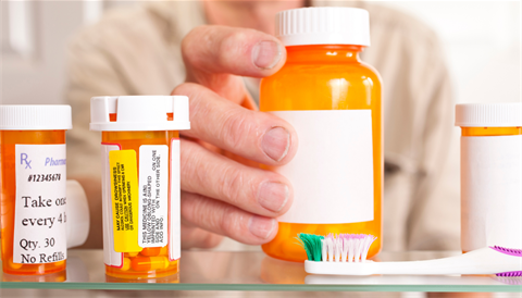 A person reaching for medicine. 