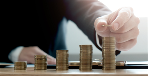 Person stacking coins. 