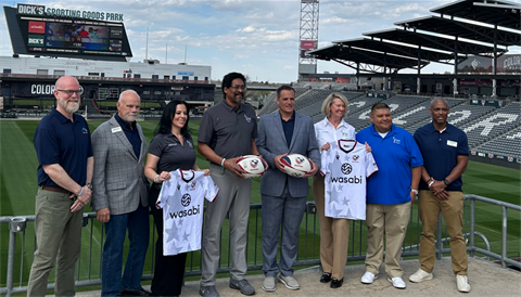 Eight people standing for a photo at Dick's Sporting Goods Park. 