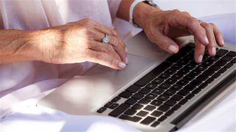 A person hands typing on a computer keyboard. 