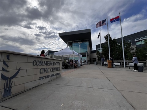 Commerce City Civic Center with crowd at Juneteenth flag raising event. 