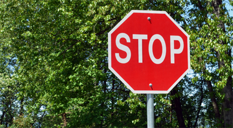 Stop sign in front of trees. 