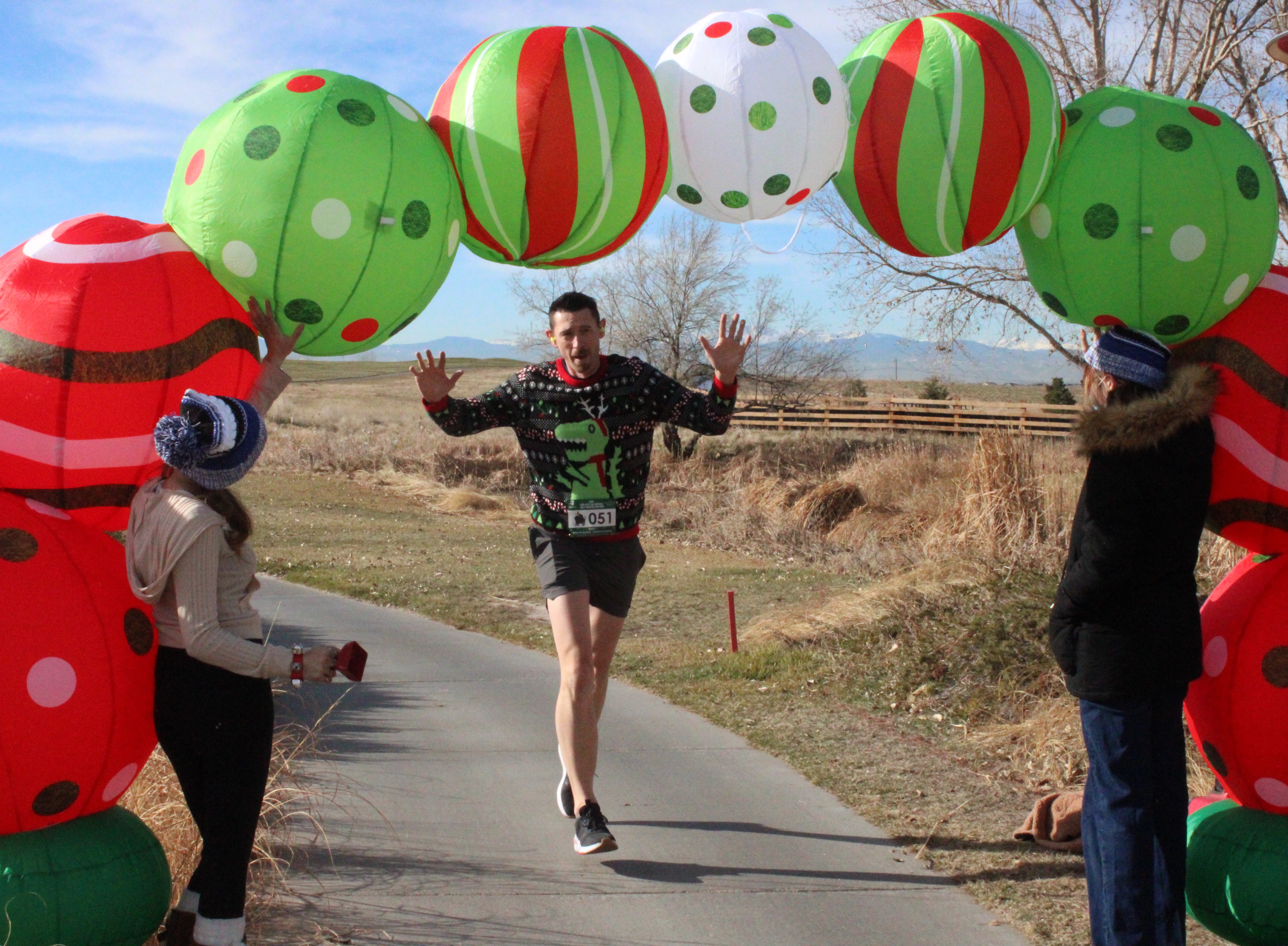 Man running through holiday arch