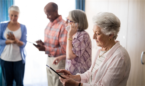 Seniors looking at mobile devices. 