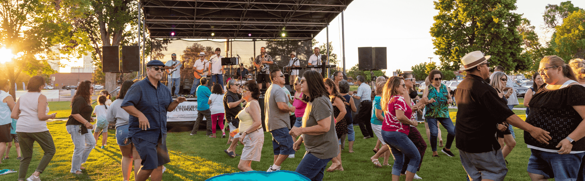 Residents dance in front of the stage as a band plays at a Music in the Park concert